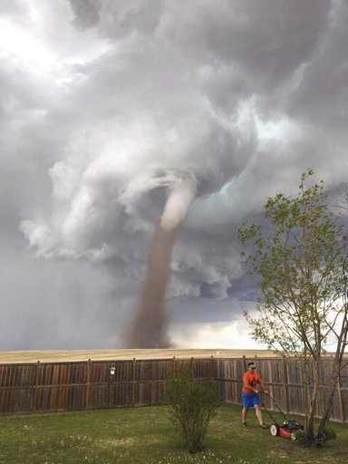 Canada Man Mowing in Tornado