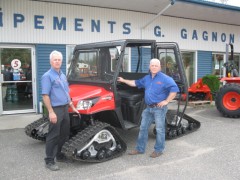 Jean and Yvon Gagnon in front of KIOTI Tractor