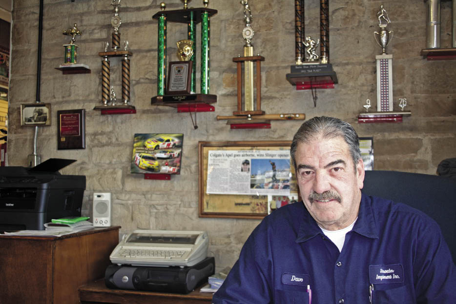 Dave Schroeder stays close to the community he’s served since 1971 through the sponsorship of local sports teams as evidenced by the trophies behind his desk. 